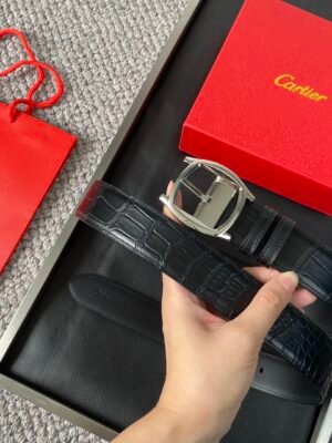 Cartier palladium plated needle buckle belt with "CARTIER" logo. Black Nile crocodile leather belt w